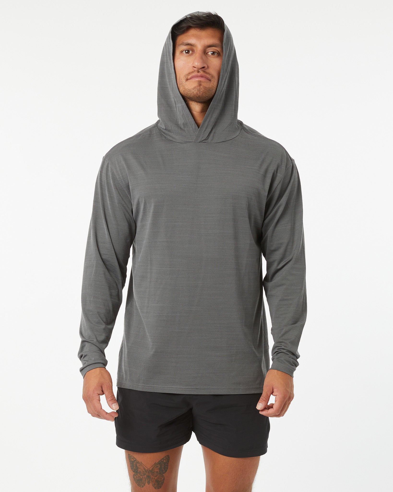 Man wearing a gray hoodie and black shorts on a white background