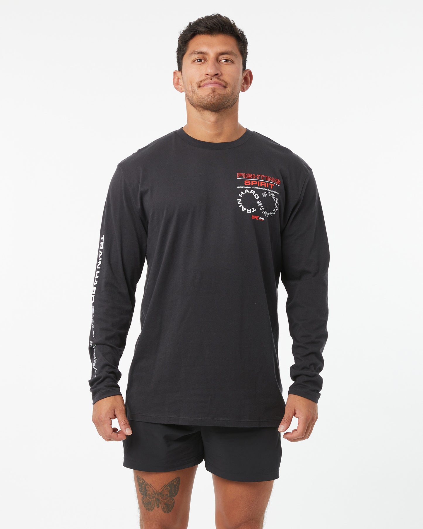 Man wearing a black long-sleeve shirt with a logo on a white background