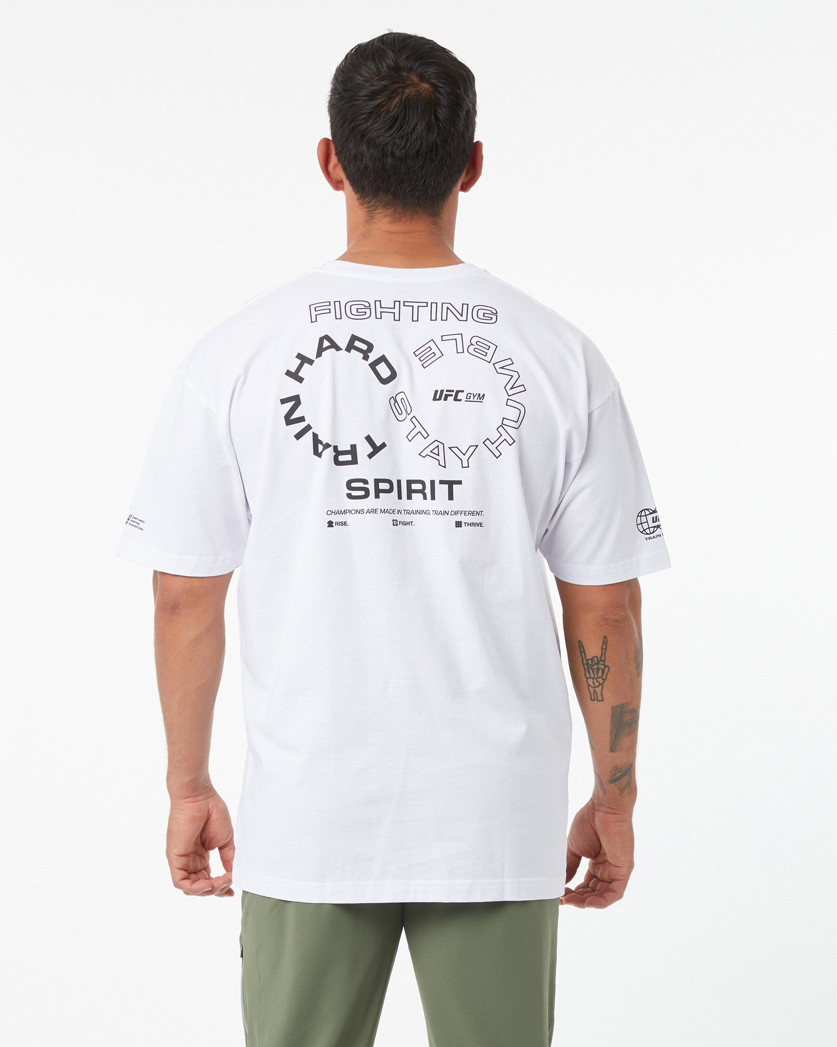 Person wearing a white UFC t-shirt with text on the back against a white background