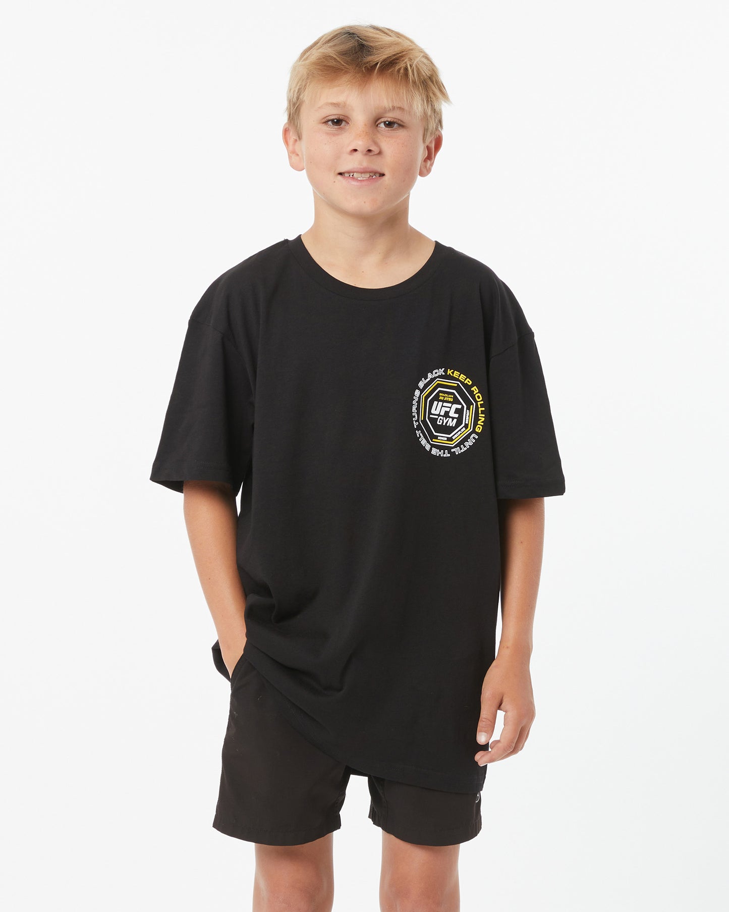 Child wearing a black t-shirt with a logo on a white background