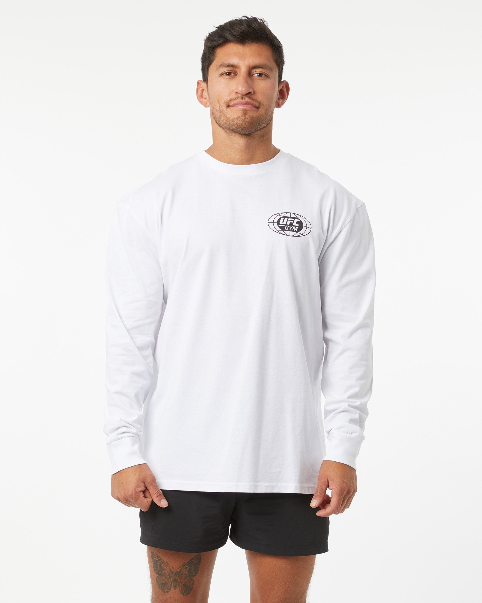 Man wearing a white long-sleeve shirt with a logo on a white background