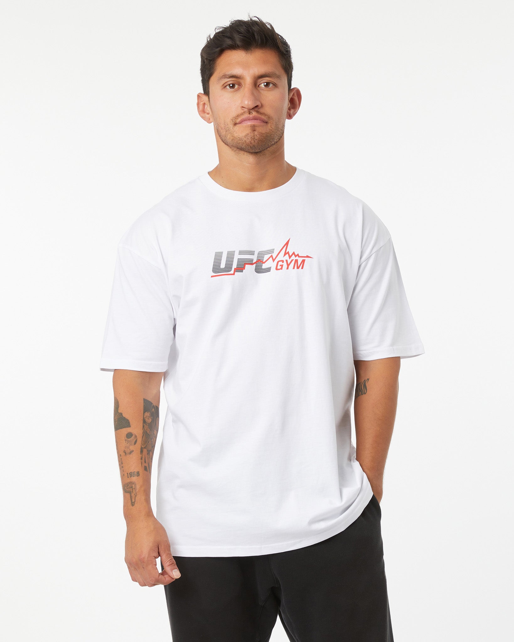 Man wearing a white UFC Gym t-shirt on a white background