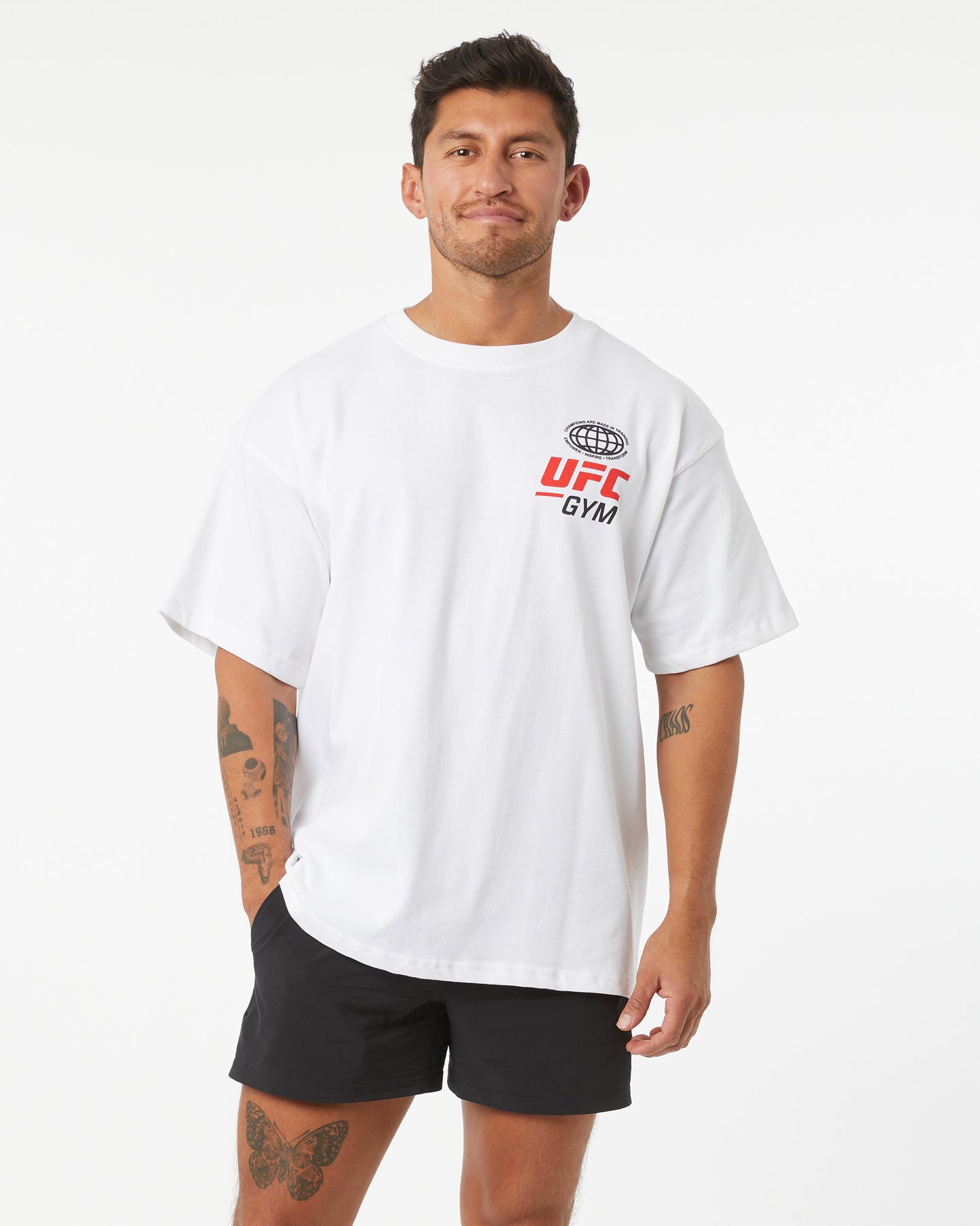 Man wearing a white UFC Gym t-shirt on a white background