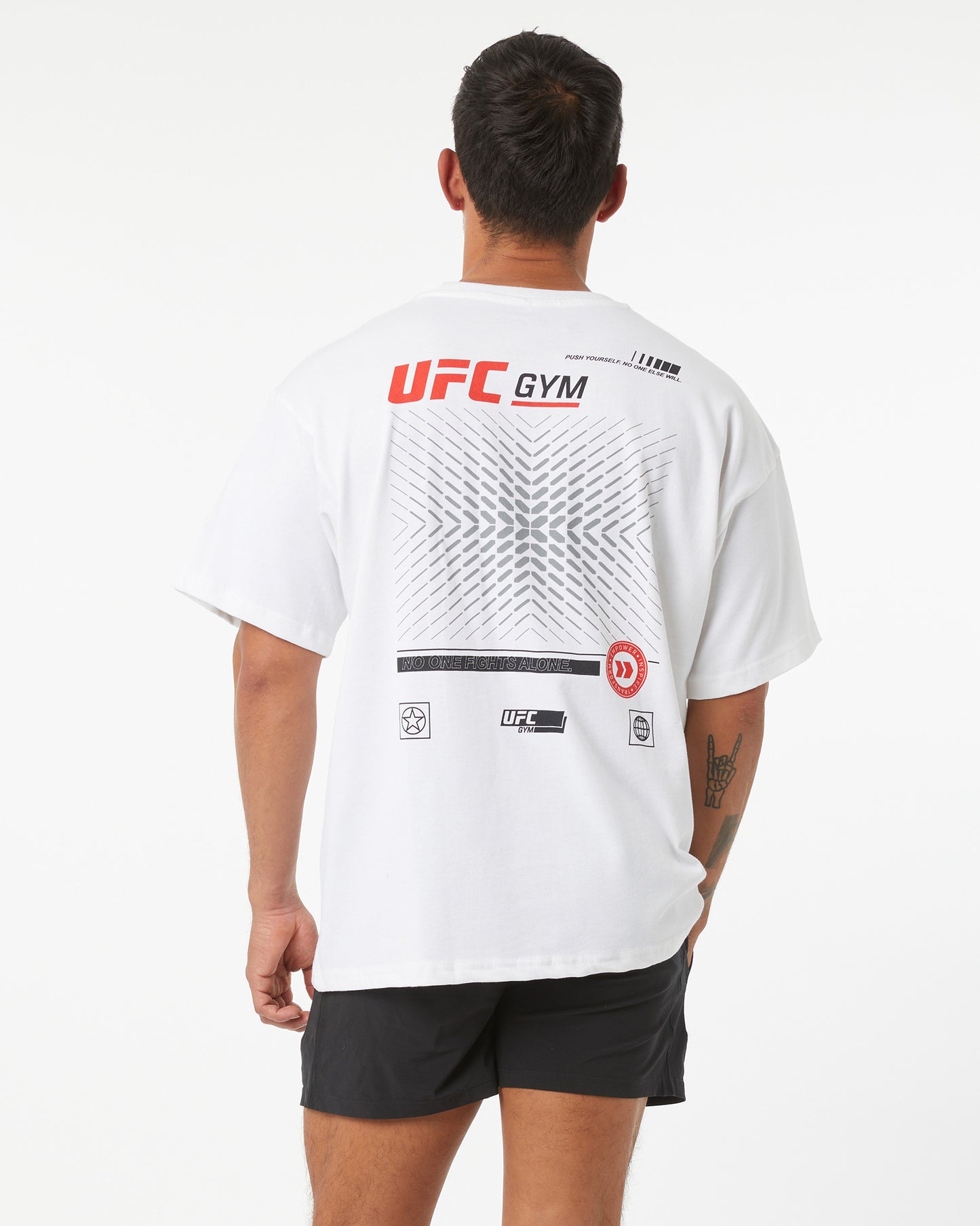 Person wearing a white UFC Gym t-shirt with branding on the back against a white background