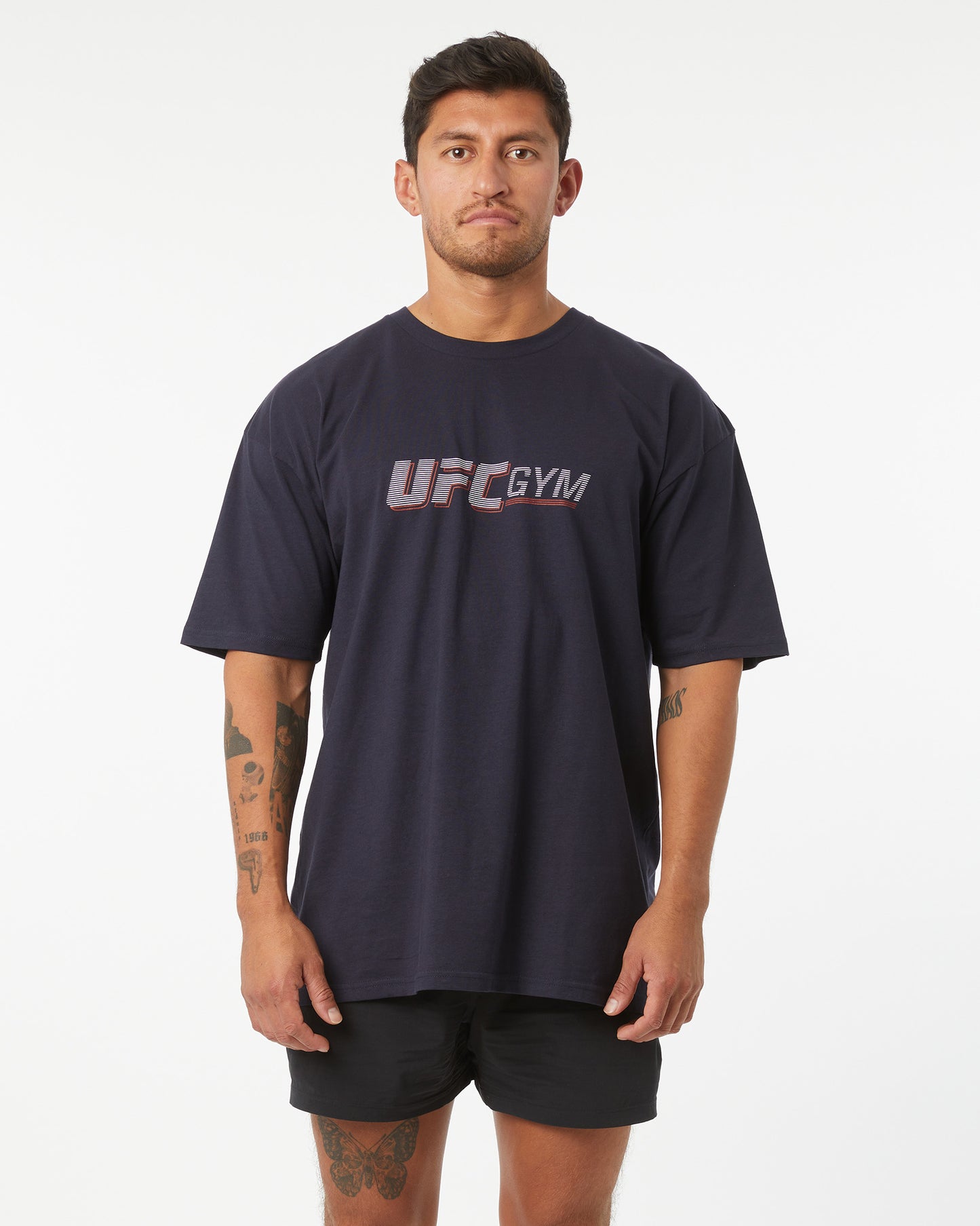 Man wearing a navy UFC Gym t-shirt on a white background