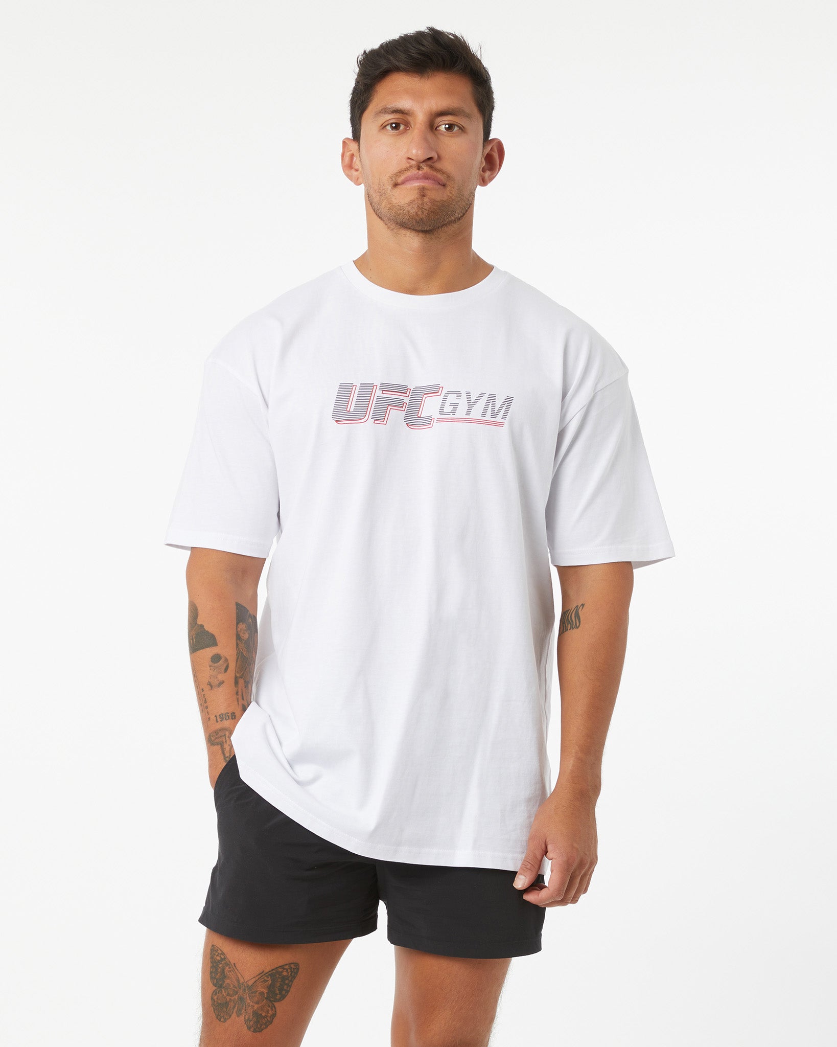 Man wearing a white UFC Gym t-shirt on a white background