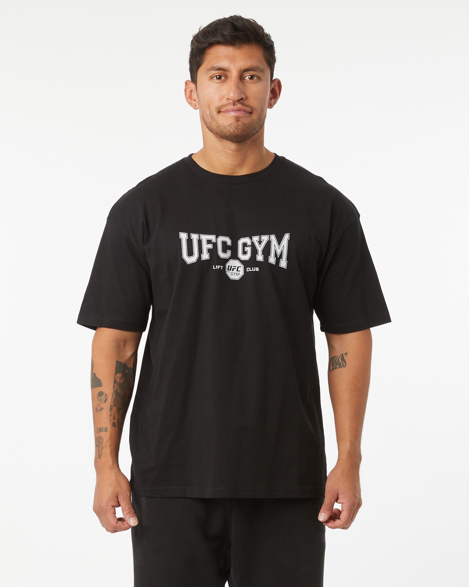 Man wearing a black UFC Gym t-shirt on a white background