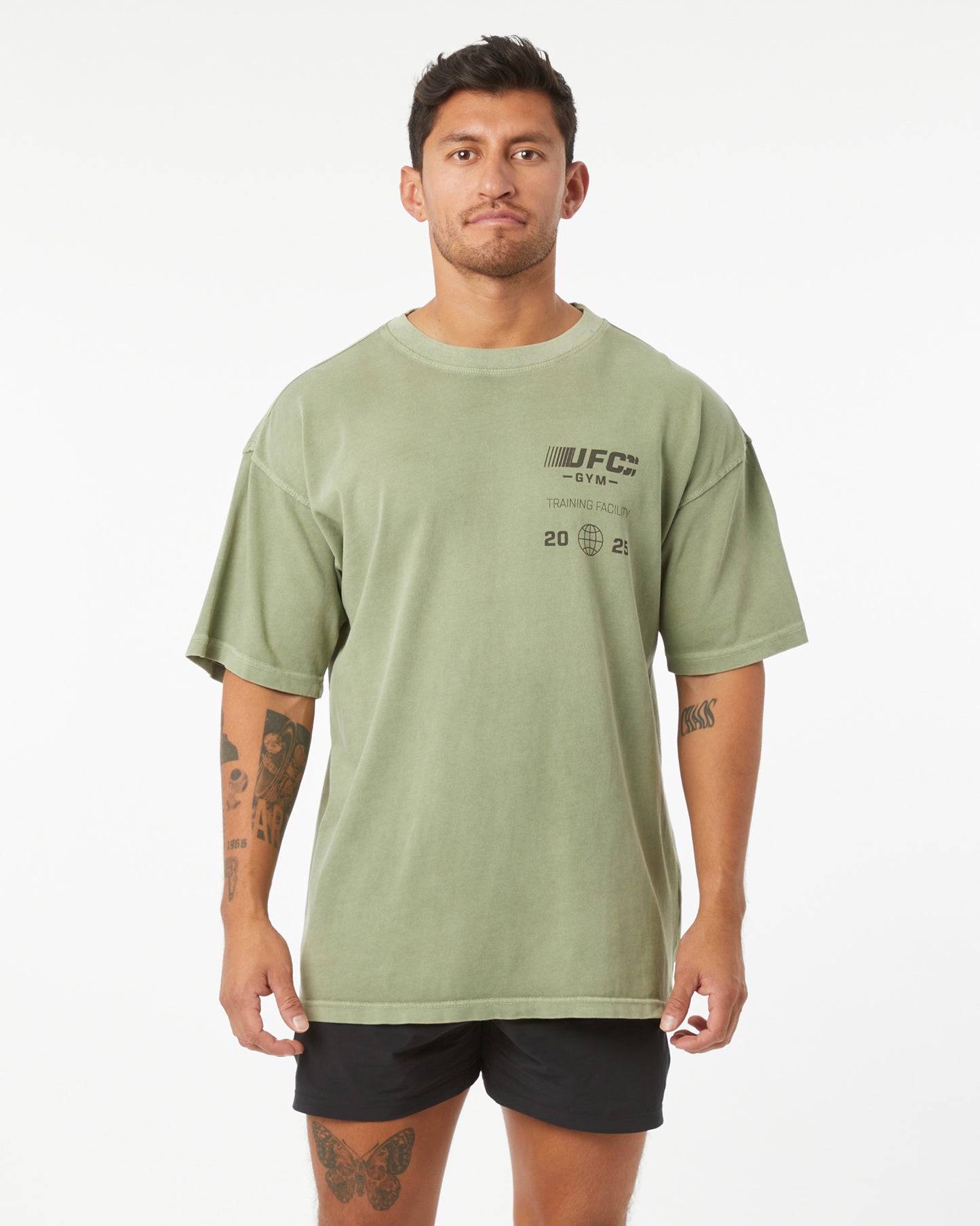 Man wearing a green t-shirt with UFC branding on a white background