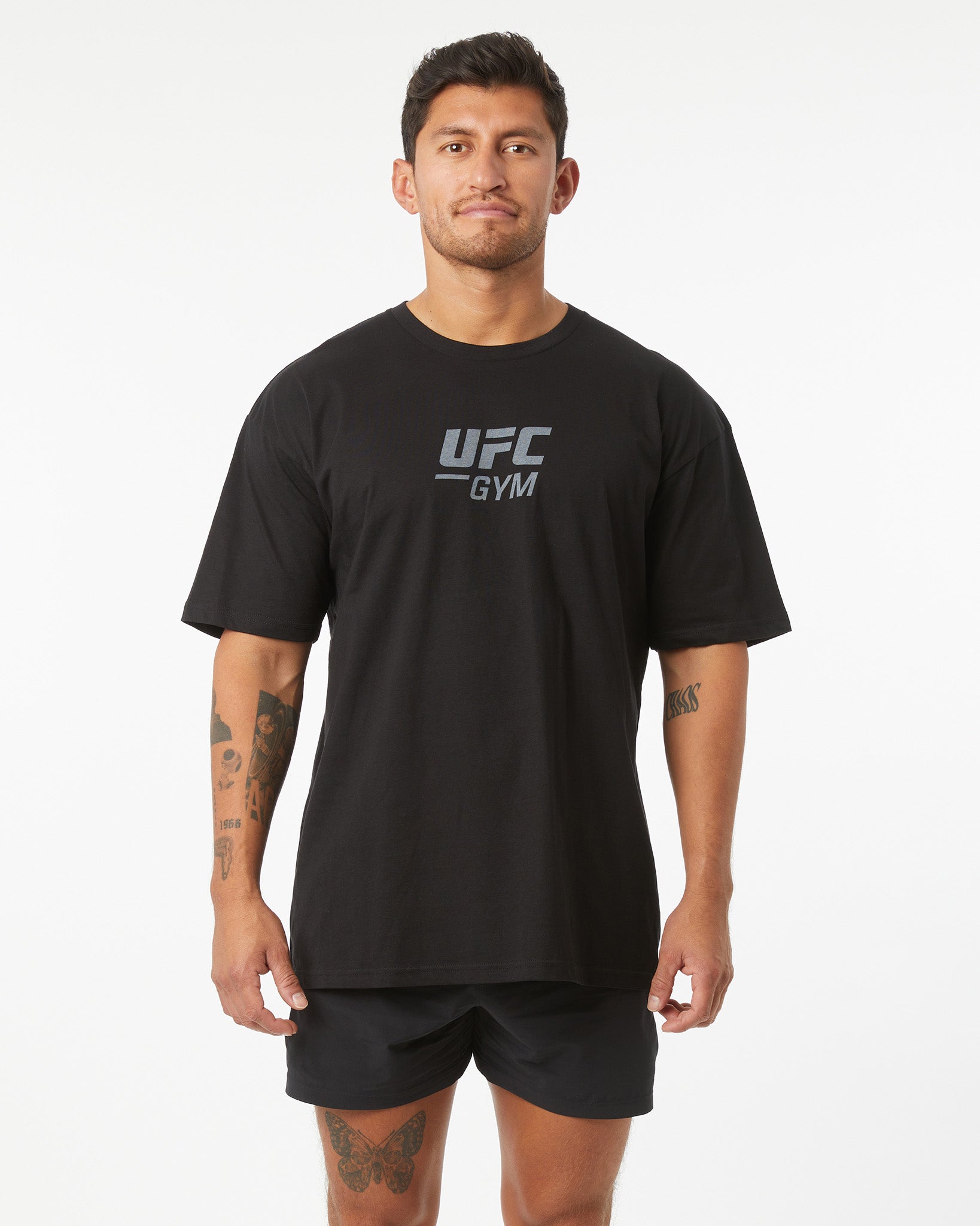 Man wearing a black UFC Gym t-shirt on a white background