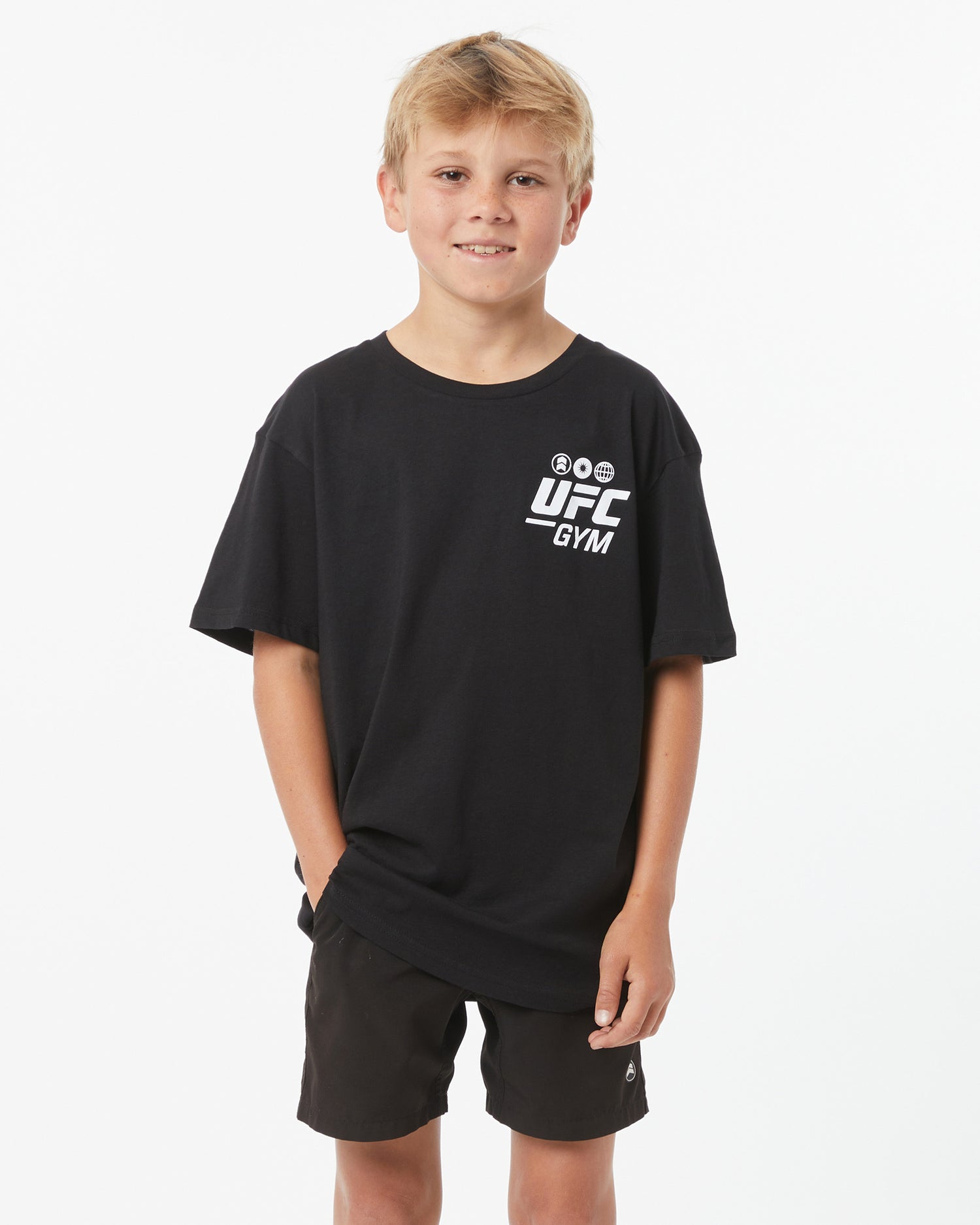 Child wearing a UFC Gym black shirt with white logo on a white background facing forward